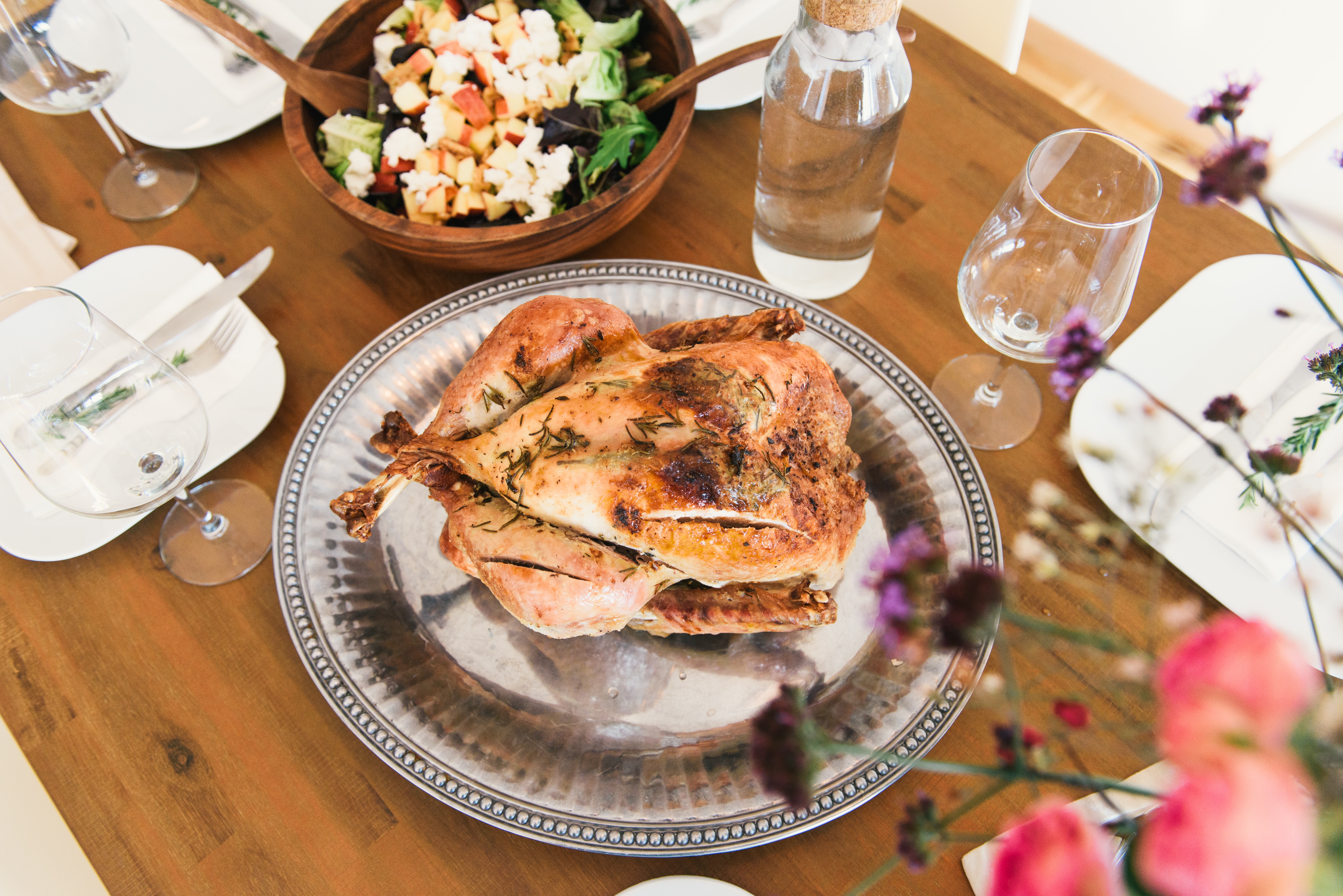 An image of a turkey and a Thanksgiving table set to show an example of Thanksgiving photography