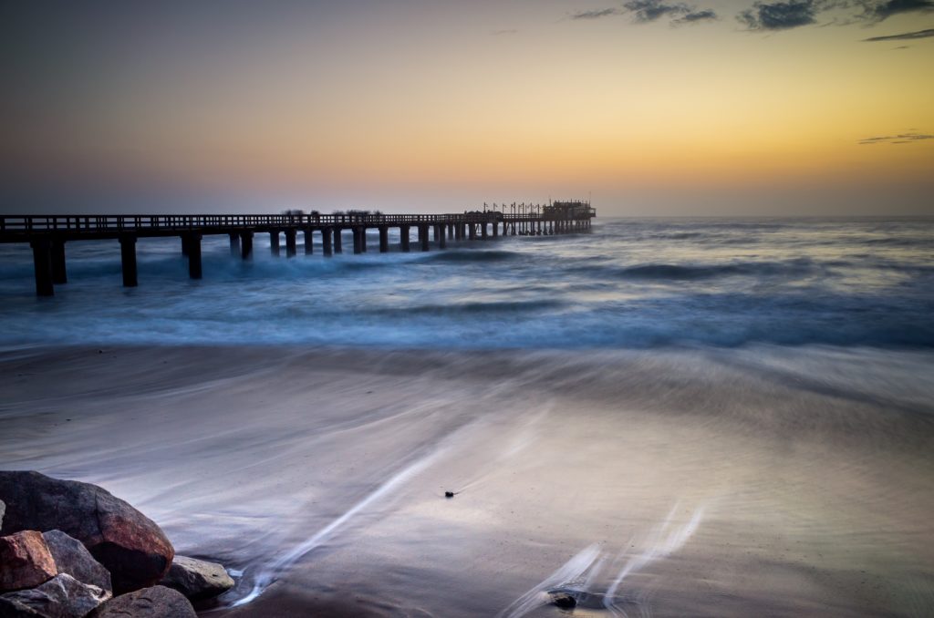 Slow shutter speed used to show waves in motion on a beach