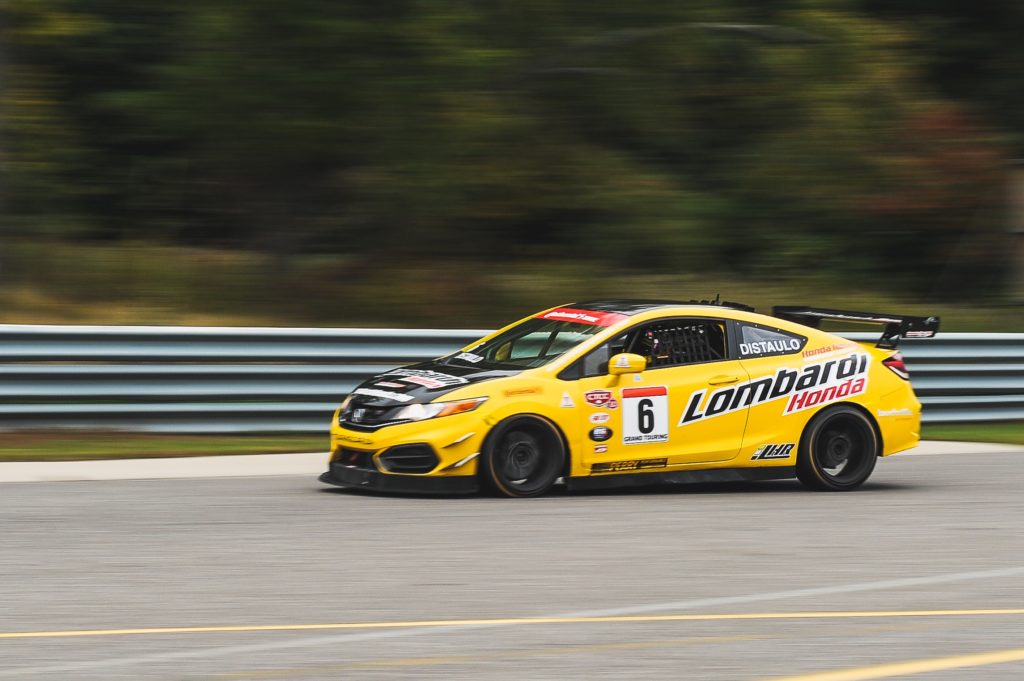 Panning used with slow shutter speed to show car and wheels in motion