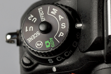 A camera mode dial set to shutter priority.