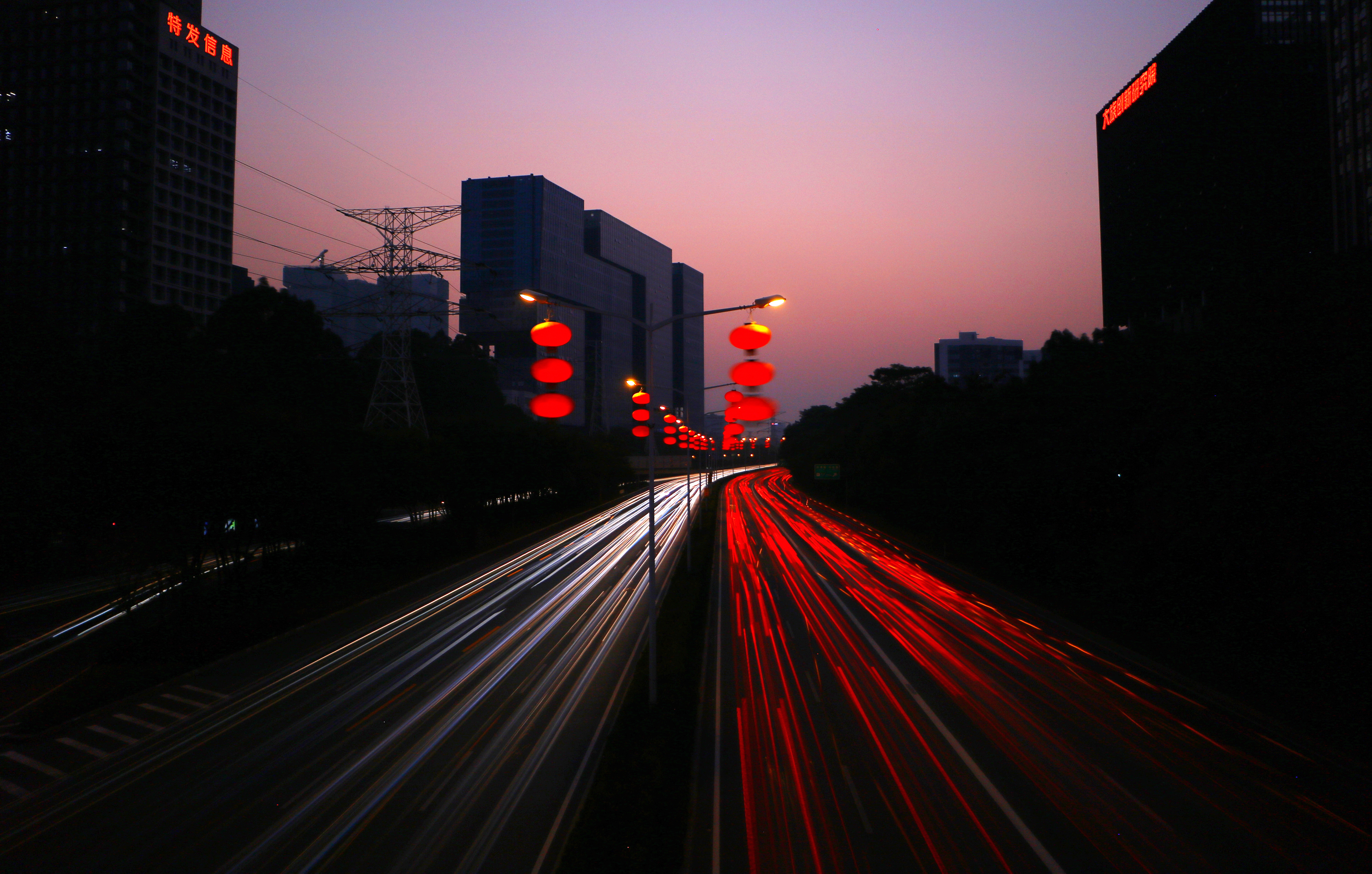 Photo of light trails from cars on a highway from using slow shutter speed