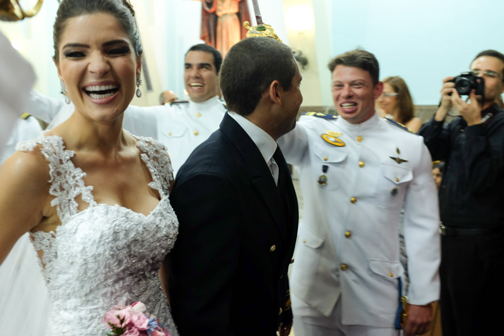 Image of a bride and groom smiling and laughing as they exit their wedding ceremony