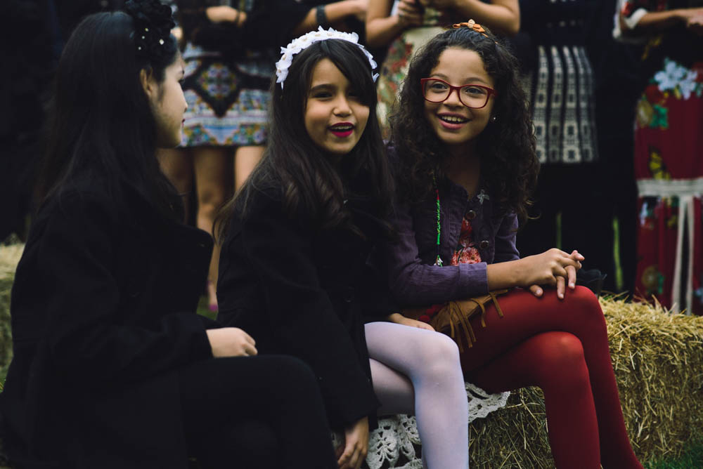 Image of young girls at wedding laughing before the start of wedding ceremony