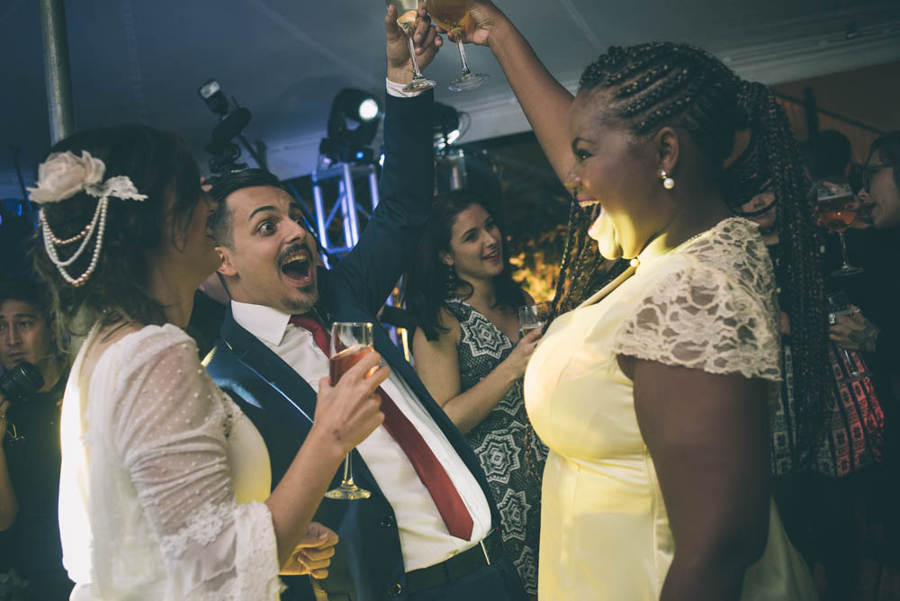 Image of happy wedding guests smiling and laughing and dancing