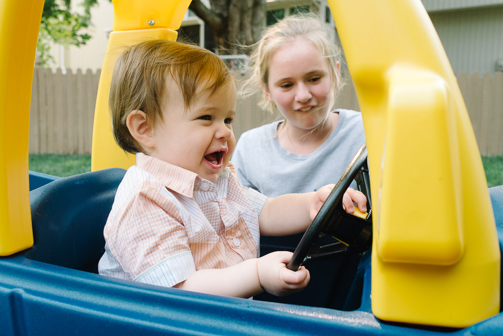 one year old getting a new car toy for his birthday party