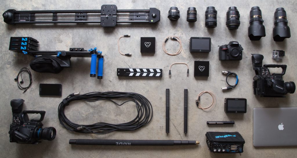 Image of DSLR lenses and other camera equipment laid out