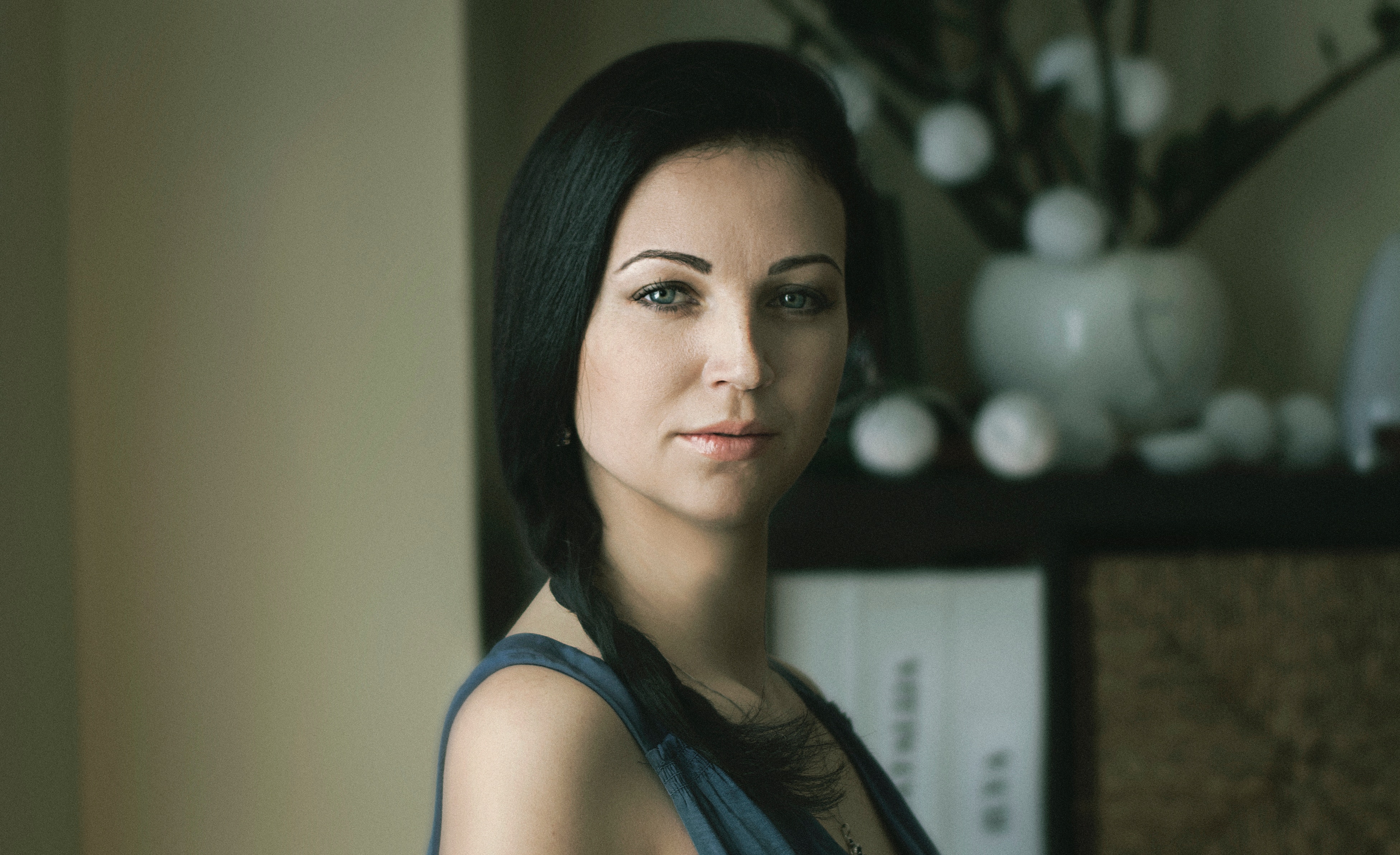 A woman with her black hair in a braid to the side.