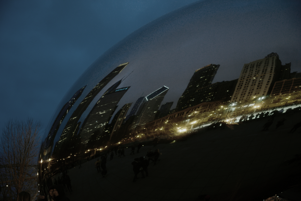 Image of the Chicago Bean dark at night with ominous reflections of buildings