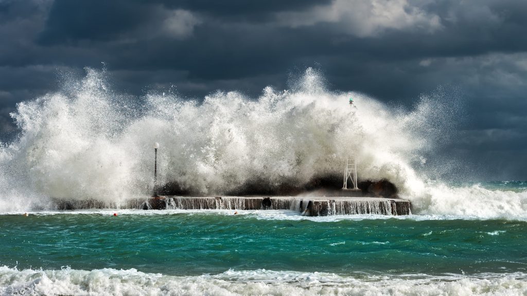 Image of a big wave crashing on some rocks