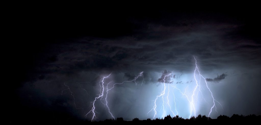 Nature photography photo of lighting striking the Earth on a dark stormy day