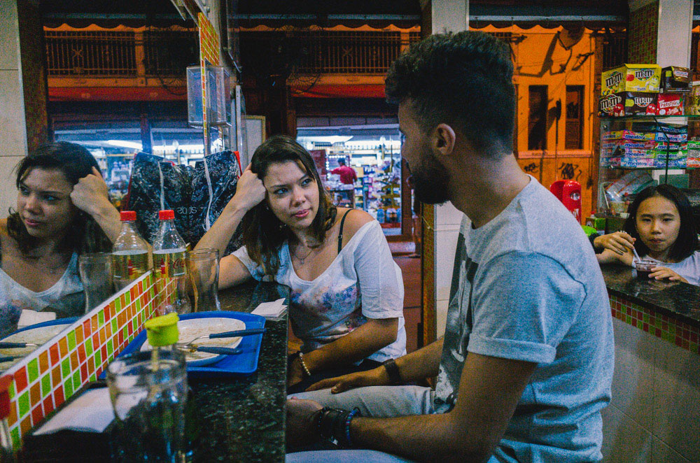 Street photography image shot up close to subjects in a cafe