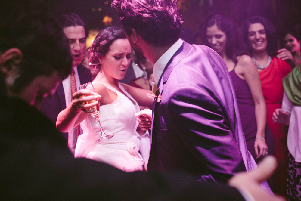 Image of a bride and groom dancing at their wedding reception shot on a 35mm lens