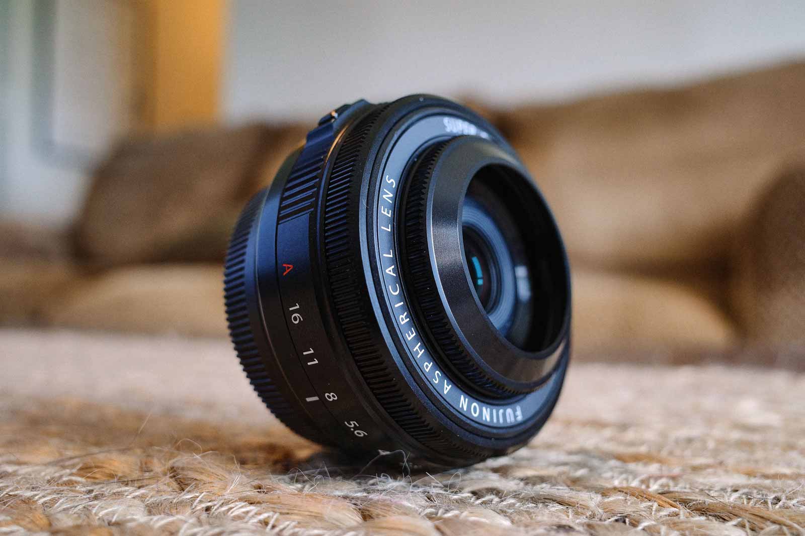 Image of the Fujifilm 27mm f/2.8 WR on a canvas surface