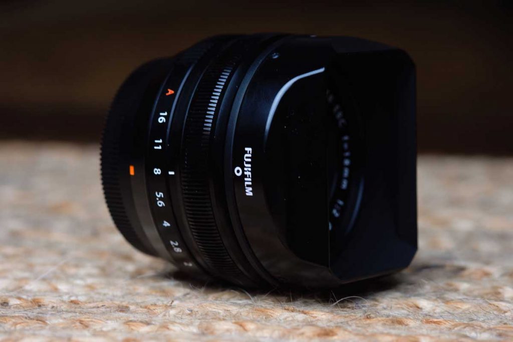 The Fujifilm 18mm f/2 with lens hood on from front angle.