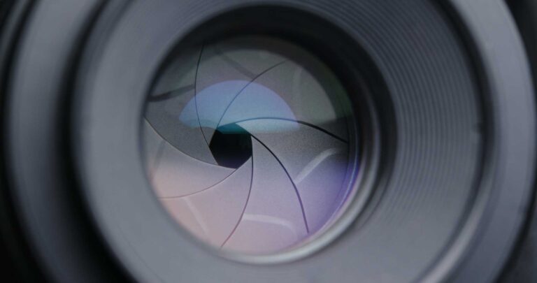 A closeup of a camera lens with the aperture blades stopped down.