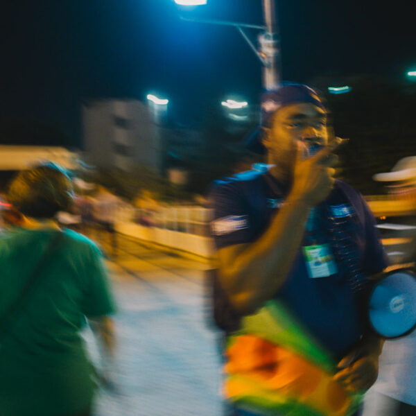 A man on a loudspeaker out of focus.
