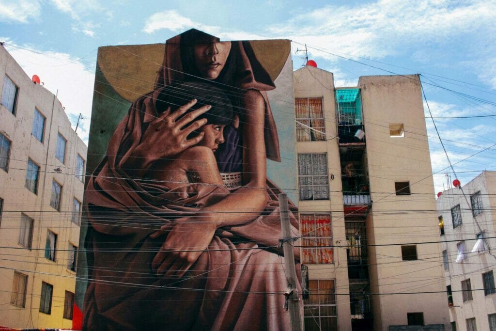 Street mural of a woman holding a child