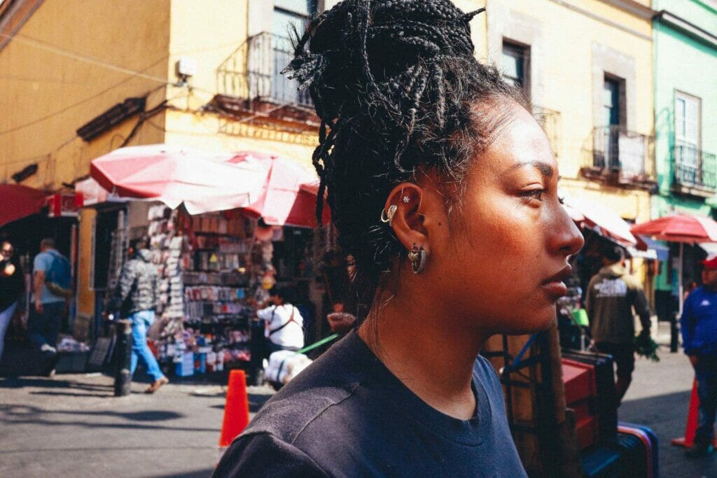 A woman on the street with hair braids.