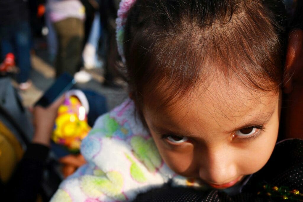 Young girl being held.