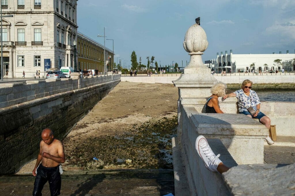 People by a bridge on a sunny day