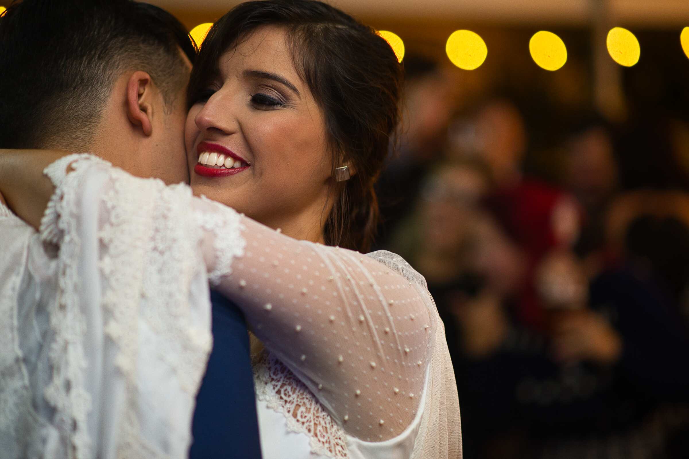 A bride smiling during her first dance.