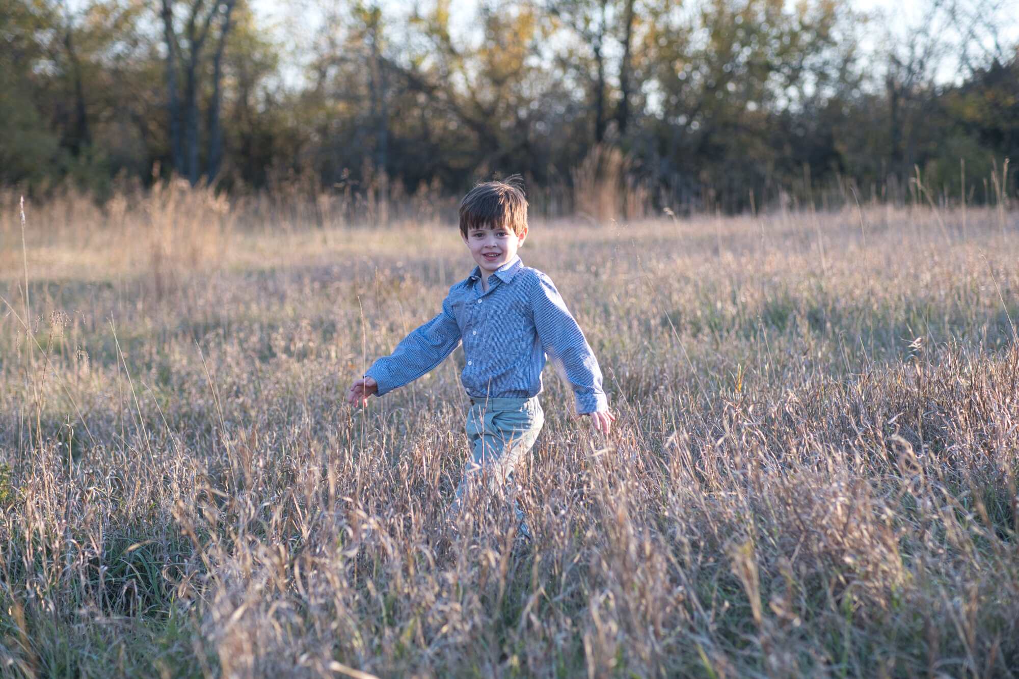 A boy in a field with no editing done to the photo.