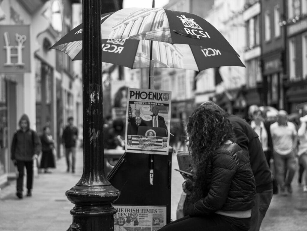 People under an umbrella.