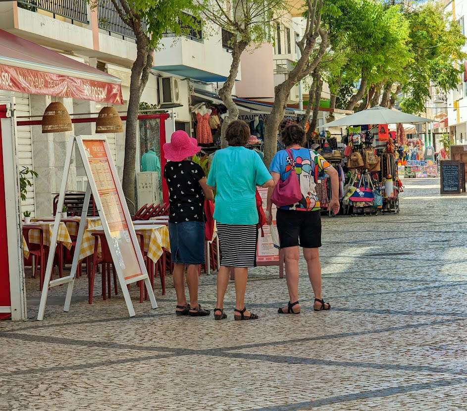 Women shopping at an outdoor market.