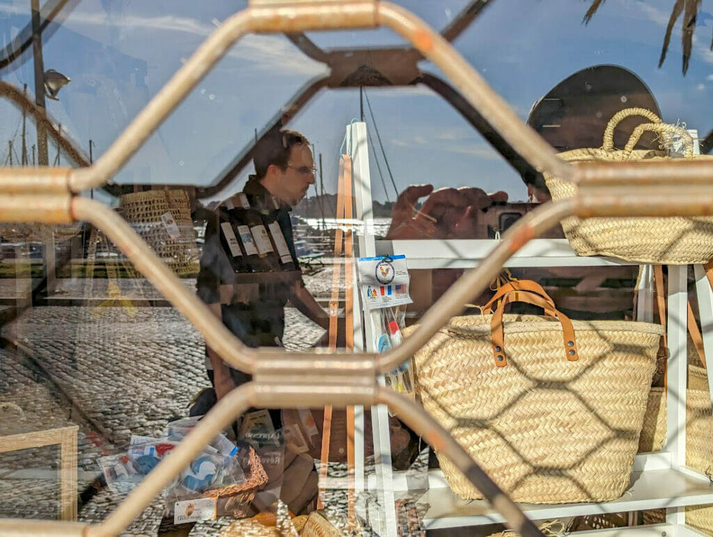 A man's reflection in a window.