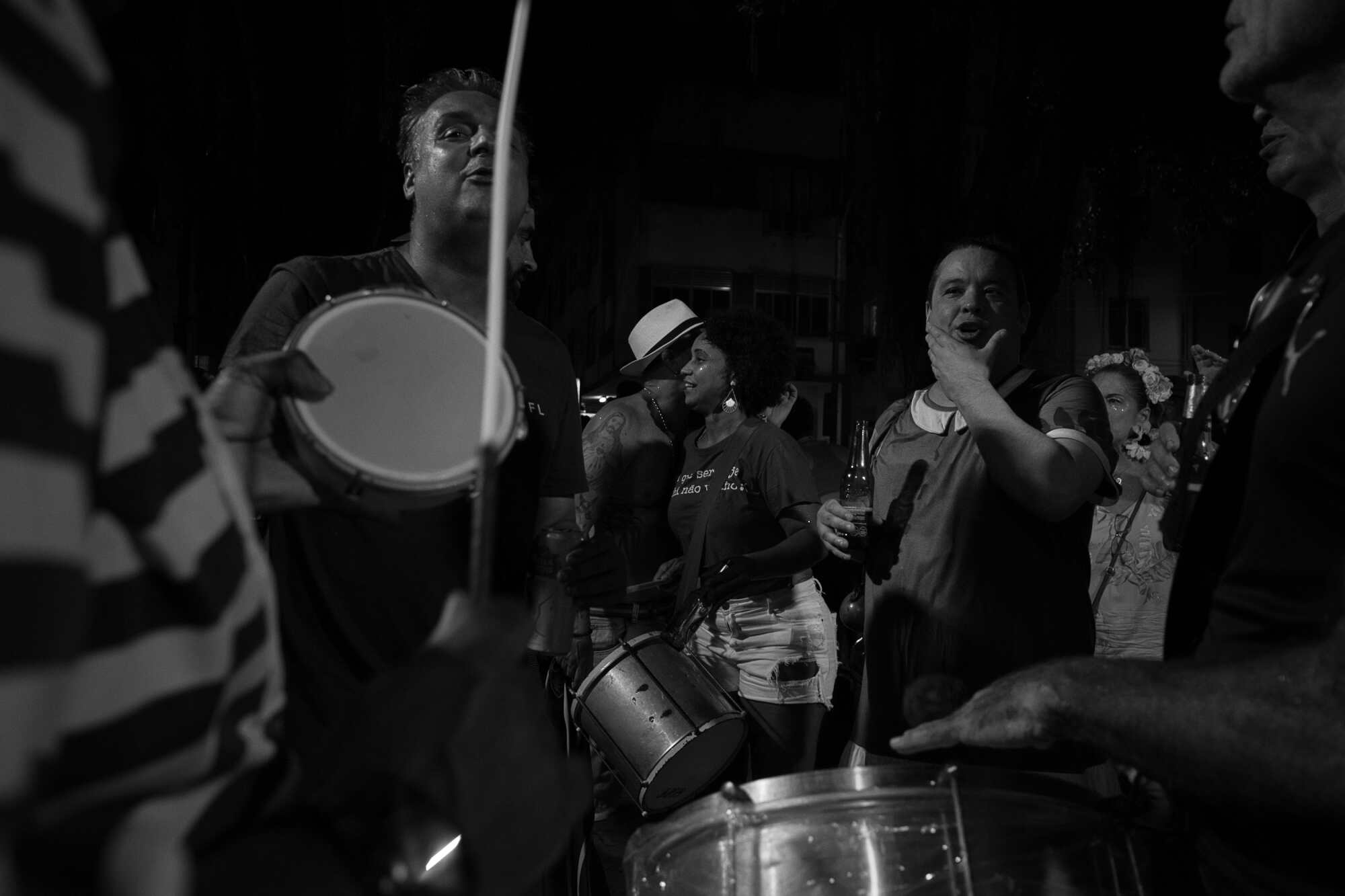 People singing and playing instruments during carnaval in Rio de Janeiro in a black & white photo.