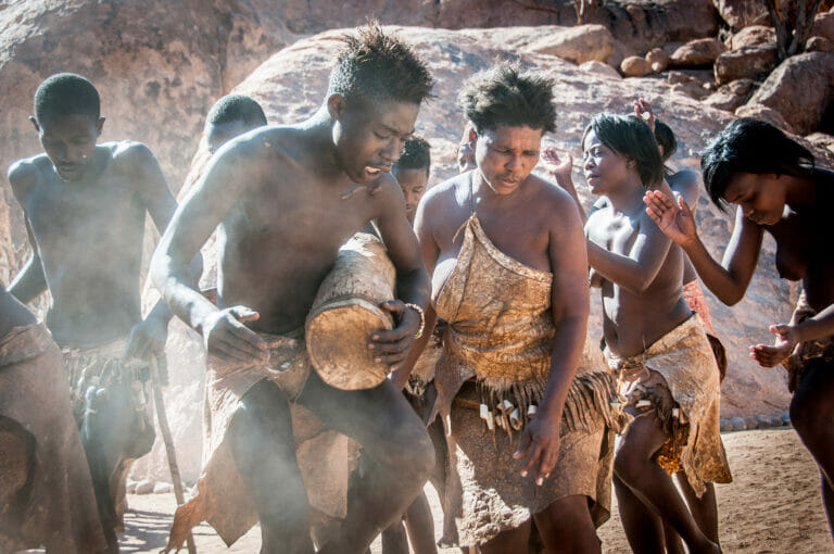 Africans doing a traditional dance and playing instruments.