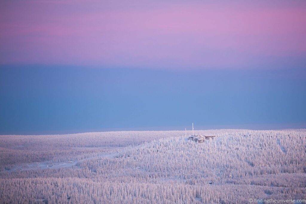 A landscape in Finland with a blue and pink sky.