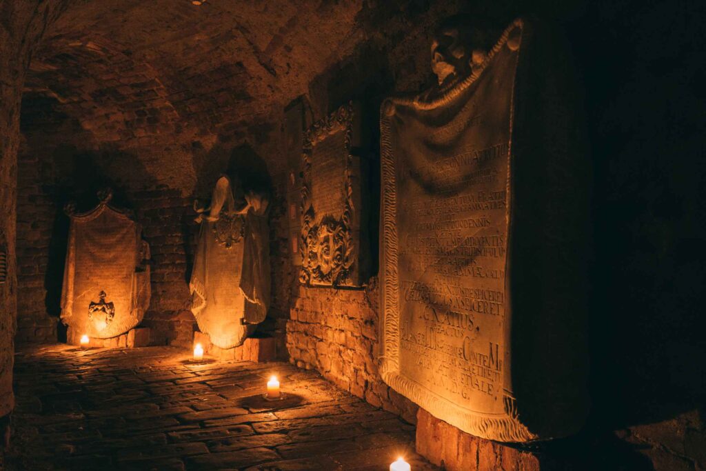 Inside an ossuary in a dark cave with dramatic lighting.